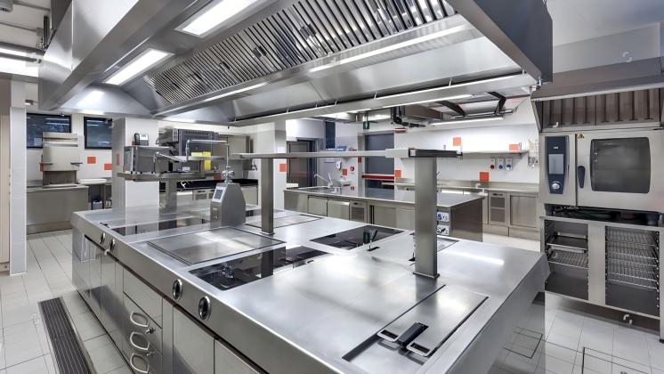 stock-photo-industrial-grade-kitchen-with-stainless-steel-surfaces-central-island-and-advanced-appliances-for-2727996519(1).jpg