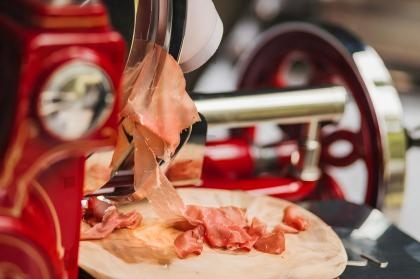 stock-photo-a-close-up-of-a-deli-slicer-machine-cutting-through-cured-meat-such-as-prosciutto-the-thin-slices-2530832203(1).jpg